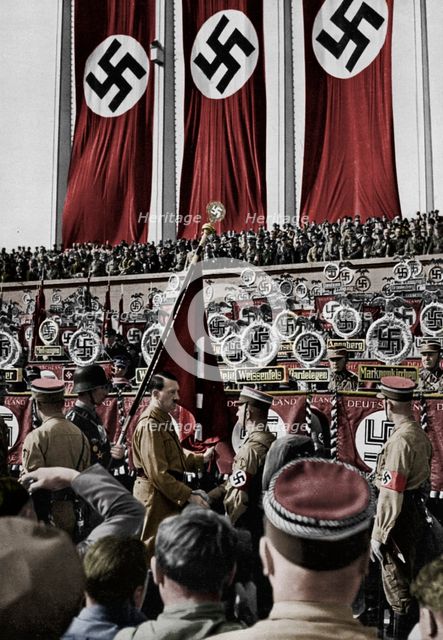 Adolf Hitler dedicates new standards, Nuremberg Rally, Germany, 1934.  Artist: Unknown.
