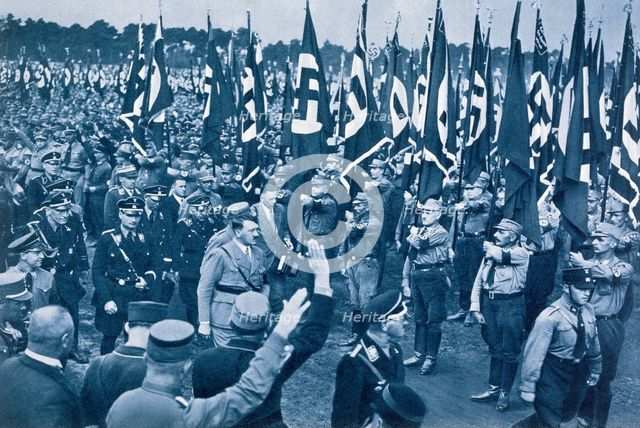 Adolf Hitler, escorted by SS leaders, inspects the SA at a Nazi rally in Nuremberg, 1933. Artist: Unknown