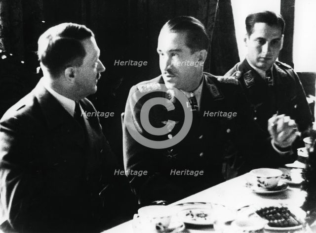 Adolf Hitler in conversation with German air force fighter ace Adolf Galland, 1941. Artist: Unknown