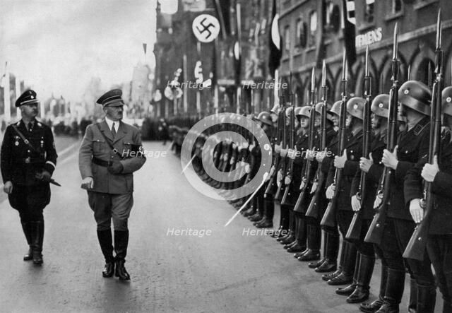Adolf Hitler reviewing Leibstandarte troops at the Nuremberg Rally, Germany, 1935. Artist: Unknown