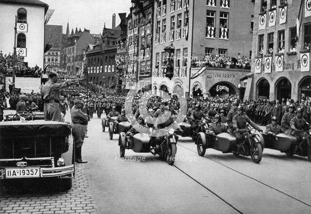 Adolf Hitler reviewing motorcycle troops at the Nuremberg Rally, Germany, 1935. Artist: Unknown