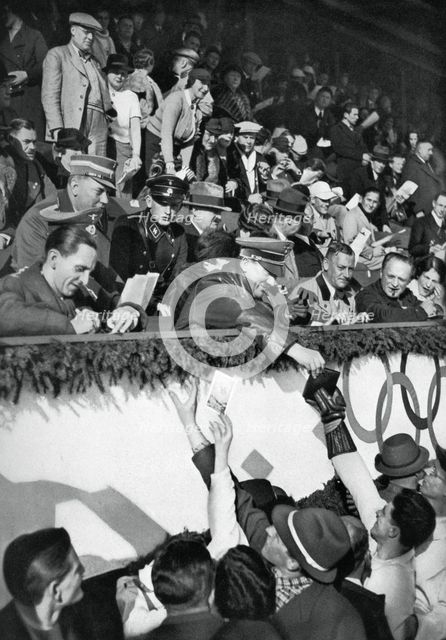 Adolf Hitler signs autographs, Winter Olympic Games, Garmisch-Partenkirchen, Germany, 1936.Artist: Schirner