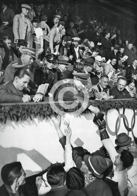 Adolf Hitler signs autographs, Winter Olympic Games, Garmisch-Partenkirchen, Germany, 1936.Artist: Schirner