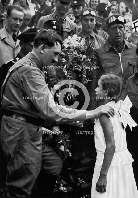 Adolf Hitler talking with a young girl during his election campaign, 1932. Artist: Unknown