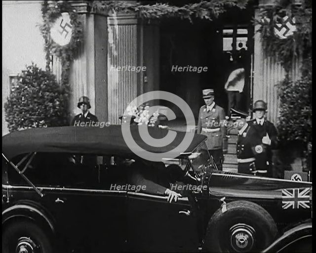 Adolf Hitler, the German Leader Coming Out of a Building in Bad Godesburg With Male German..., 1938. Creator: British Pathe Ltd.