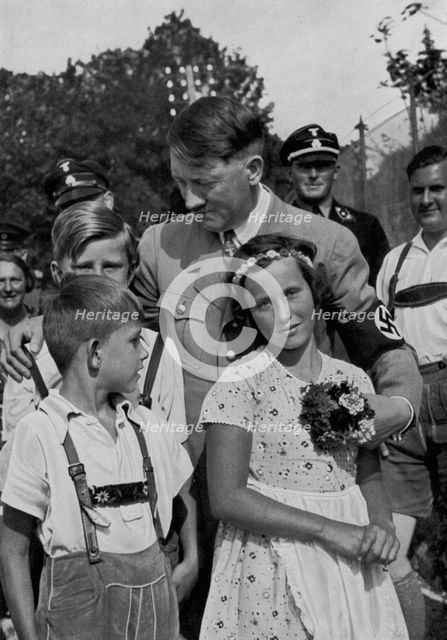 Adolf Hitler with a group of young children, 1936. Artist: Unknown