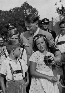 Adolf Hitler with a group of young children, 1936