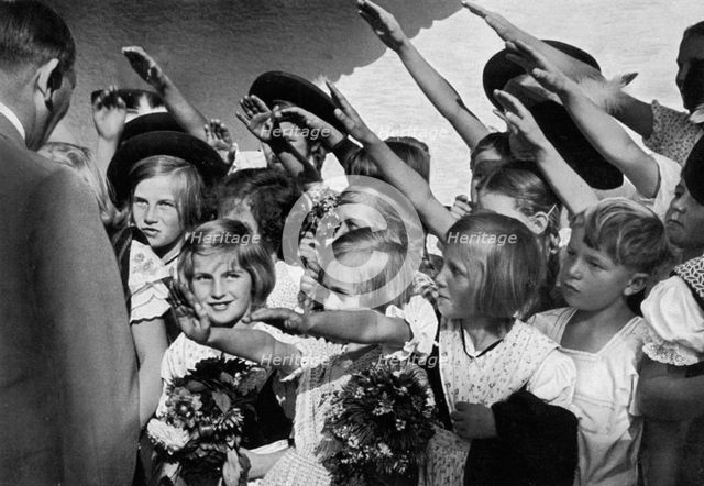 Adolf Hitler with a group of young children, 1936. Artist: Unknown