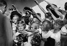 Adolf Hitler with a group of young children, 1936