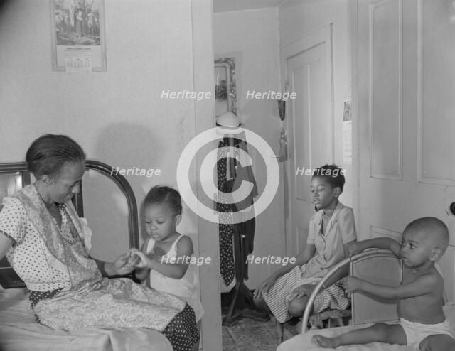 Adopted daughter and two grandchildren with Mrs. Ella Watson...charwoman, Washington, D.C, 1942. Creator: Gordon Parks.