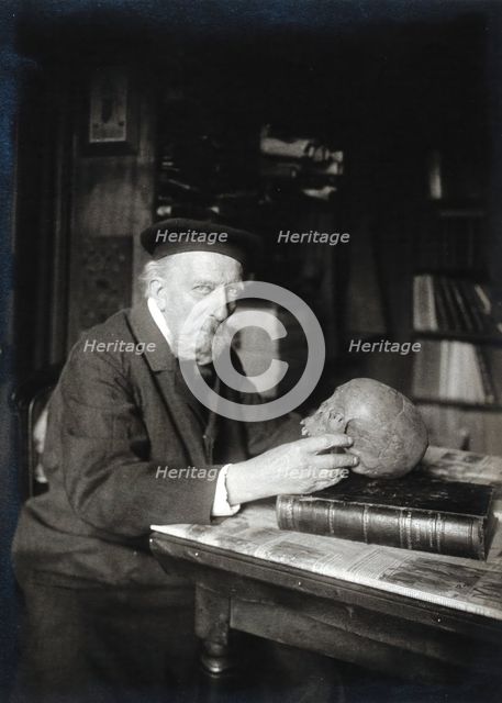 Adrien de Mortillet, holding a skull. Creator: Unknown.