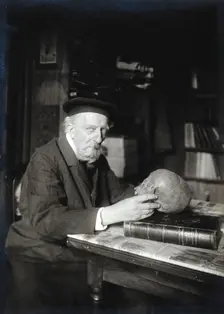 Adrien de Mortillet, holding a skull. Creator: Unknown