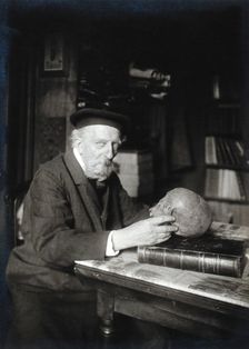 Adrien de Mortillet, holding a skull. Creator: Unknown