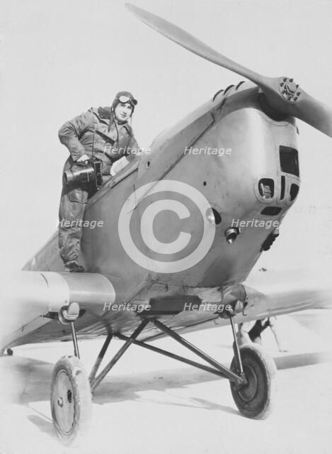 Aerial photographer getting into an aeroplane, c1930s. Creator: Aerofilms.