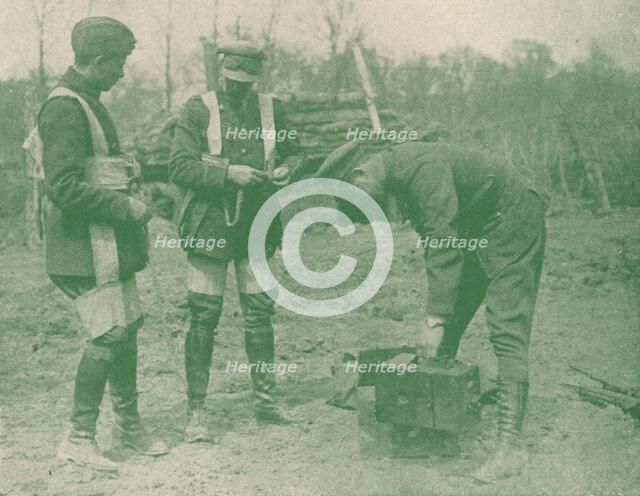 Aerial photographers fixing on parachute harnesses before making an ascent, c1917 (1919). Artist: Unknown.