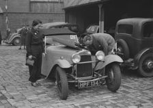 AES Curtis looking under the bonnet of his HRG at the RAC Rally, 1939. Artist: Bill Brunell
