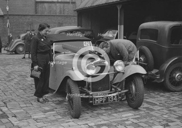 AES Curtis looking under the bonnet of his HRG at the RAC Rally, 1939. Artist: Bill Brunell.