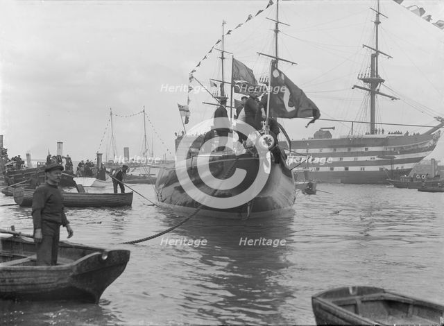 After launch of 'Shamrock IV' at Gosport with H.M.S. Victory in the background, May 1914. Creator: Kirk & Sons of Cowes.