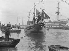 After launch of Shamrock IV at Gosport with H.M.S. Victory in the background, May 1914. Creator: Kirk & Sons of Cowes