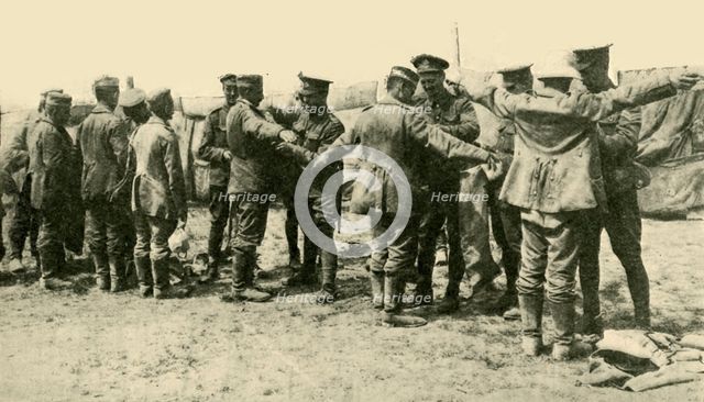 'After the Battle: searching German prisoners of war...', First World War, c1916, (c1920).  Creator: Unknown.