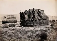 Africa: a group of African people standing on a kraal hut, between 1800 and 1899. Creator: Unknown