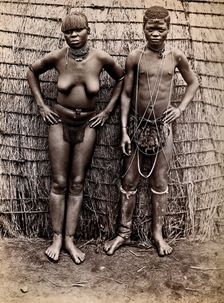 Africa: an African woman and man in front of a kraal hut, 19th century. Creator: Unknown