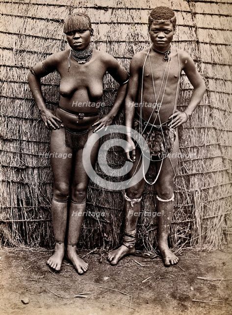 Africa: an African woman and man in front of a kraal hut, 19th century. Creator: Unknown.
