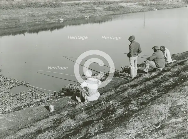 African American migrant laborers fishing in Belle Glade, Florida, January 1939. Creators: Farm Security Administration, Marion Post Wolcott.