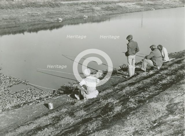 African American migrant laborers fishing in Belle Glade, Florida, January 1939. Creators: Farm Security Administration, Marion Post Wolcott.