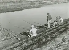 African American migrant laborers fishing in Belle Glade, Florida, January 1939. Creators: Farm Security Administration, Marion Post Wolcott