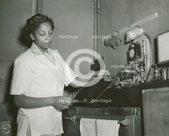 African American Private Hannah Wills developing an x-ray film in the x-ray laboratory..., 1943. Creator: Unknown.