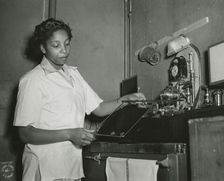 African American Private Hannah Wills developing an x-ray film in the x-ray laboratory..., 1943. Creator: Unknown