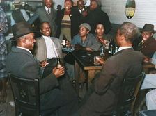 African Americans conversing and drinking beers in a bar, Clarksdale, Mississippi Delta, Nov 1939. Creators: Farm Security Administration, Marion Post Wolcott