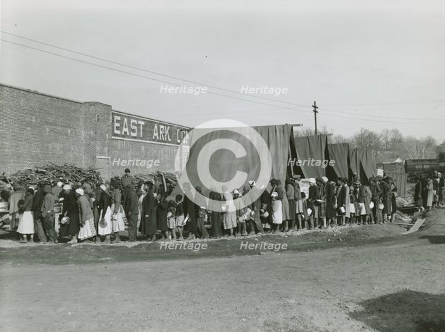 African Americans holding their pots and pans, and waiting for their turn to get meals, Feb. 1937. Creators: Farm Security Administration, Edwin Locke.