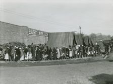 African Americans holding their pots and pans, and waiting for their turn to get meals, Feb. 1937. Creators: Farm Security Administration, Edwin Locke