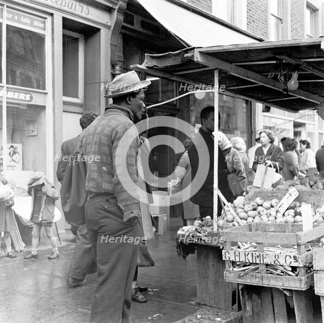 Afro-Caribbean man in a market, London, c1960-c1980. Creator: Henry Grant.