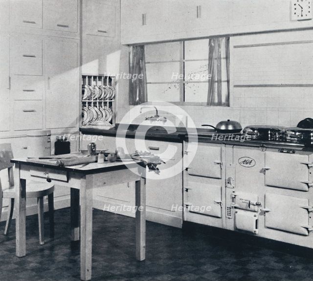 'Aga Heat Ltd. The Model F Aga Cooker (for a large house) finished in black and cream vitreous ename Artist: Unknown.