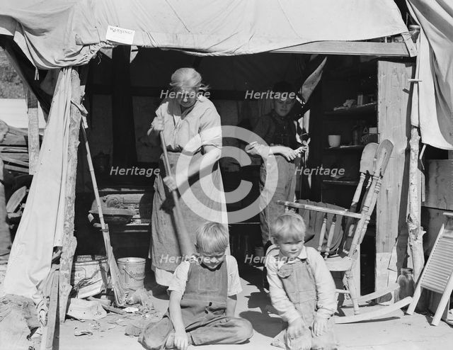 Aged woman with three of her twenty-two grandchildren, Kern county migrant camp, California, 1936. Creator: Dorothea Lange.