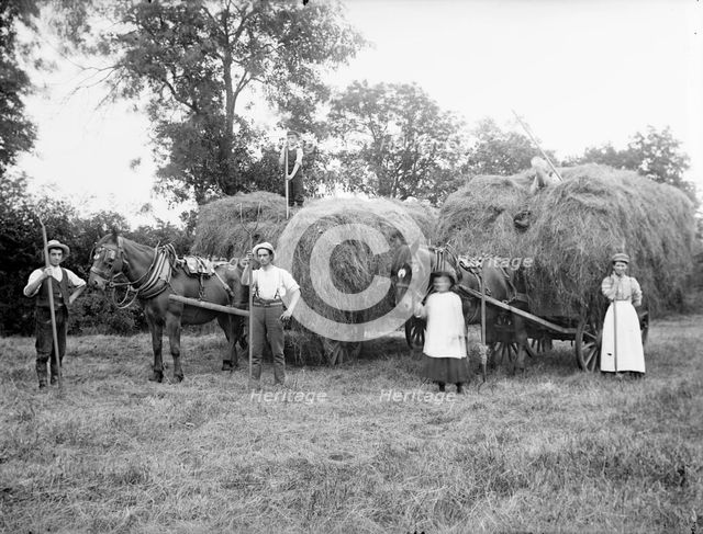Agricultural workers pose next to loaded hay waggons near Hellidon, Northamptonshire, c1873-c1923. Artist: Alfred Newton & Sons