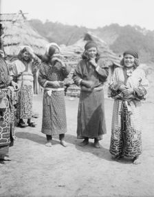 Ainu woman outside in the village lane, 1908. Creator: Arnold Genthe