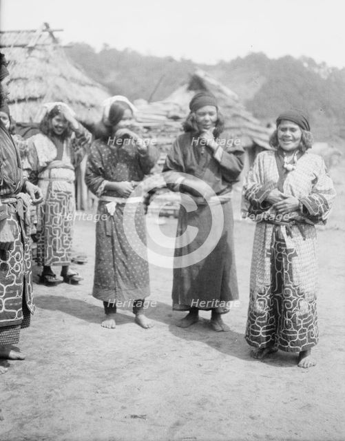 Ainu woman outside in the village lane, 1908. Creator: Arnold Genthe.