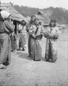 Ainu woman outside in the village lane, 1908. Creator: Arnold Genthe
