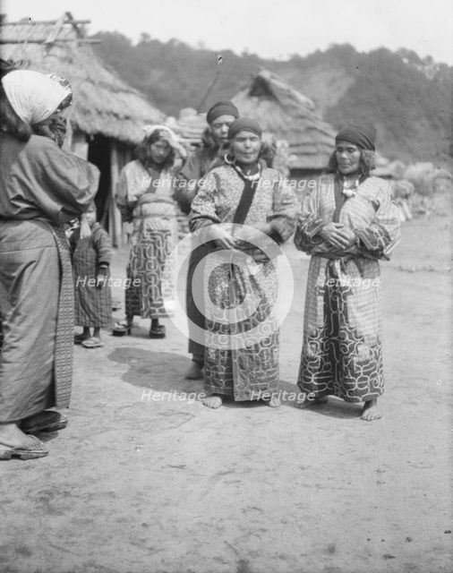 Ainu woman outside in the village lane, 1908. Creator: Arnold Genthe.