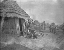 Ainu women and children outside a hut, 1908. Creator: Arnold Genthe