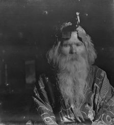 Ainu chief wearing a headdress, 1908. Creator: Arnold Genthe