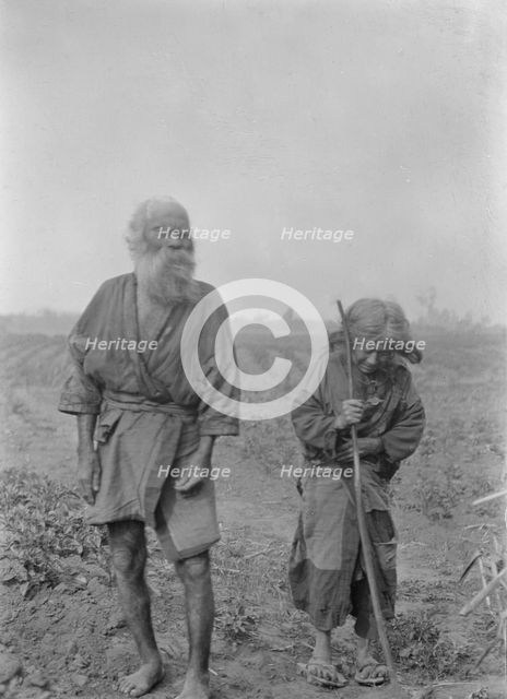 Ainu man and woman standing outside, 1908. Creator: Arnold Genthe.