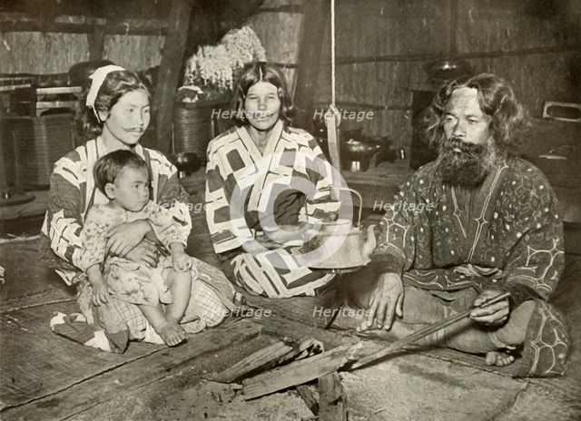 'Ainu Man and Women at Home', 1910. Creator: Herbert Ponting.