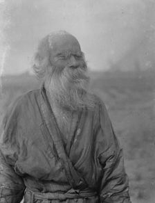 Ainu man standing outside, 1908. Creator: Arnold Genthe