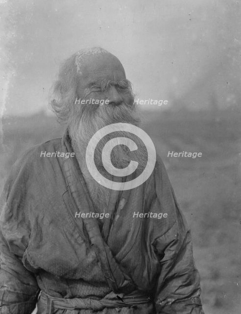 Ainu man standing outside, 1908. Creator: Arnold Genthe.