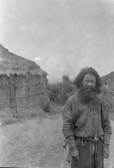 Ainu man standing outside, 1908. Creator: Arnold Genthe